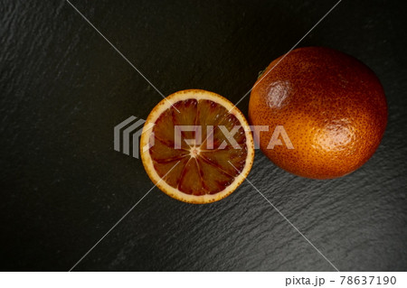 Close up of blood orange on a black plate Close up of blood orange on a black plate 78637190