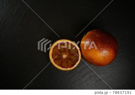 wide shot of blood orange on a black plate wide shot of blood orange on a black plate 78637191