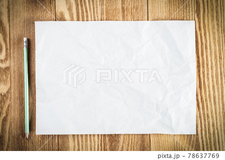 Sheet of paper lying on wooden table Sheet of paper lying on wooden table 78637769