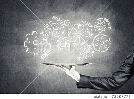 Waiter hand with empty silver tray and drawn gears concept Waiter hand with empty silver tray and drawn gears concept 78637772