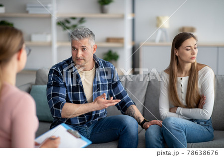 Unhappy mature couple having meeting with marital counselor, discussing relationship problems Unhappy mature couple having meeting with marital counselor, discussing relationship problems 78638676