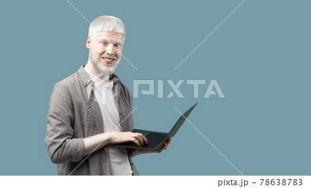 Remote job for students. Excited extraordinary guy with laptop computer standing over blue background with copy space Remote job for students. Excited extraordinary guy with laptop computer standing over blue background with copy space 78638783