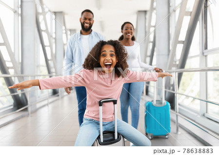 Happy black family traveling with kid, walking in airport 78638883