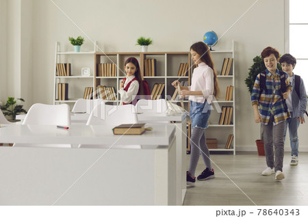 Elementary children entering classroom after a noon recess between lessons 78640343