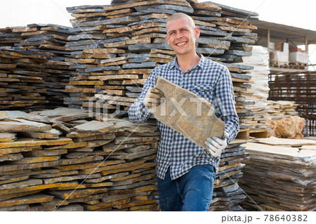 Buyer selects facing stone at an open-air construction site Buyer selects facing stone at an open-air construction site 78640382