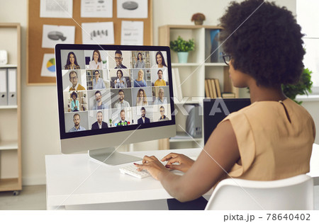 Woman having an online business conference or a video call meeting with colleagues 78640402