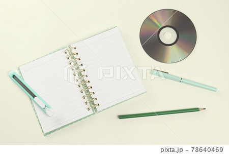 flat lay green color stationery and CD 78640469