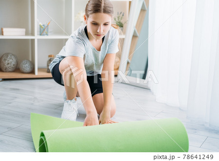 active kids home pilates girl unrolling yoga mat active kids home pilates girl unrolling yoga mat 78641249