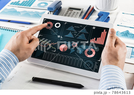 Businessman with a computer tablet at a work desk Businessman with a computer tablet at a work desk 78643613