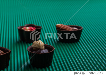 Close-up various assorted chocolate candies with nuts. 78643947