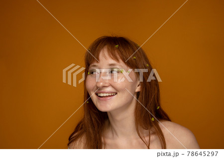 Romantic girl with green flowers at the hair and face 78645297