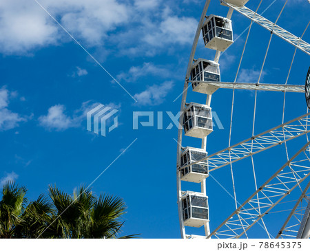 Ferris wheel in a sunny day with withe clouds Ferris wheel in a sunny day with withe clouds 78645375