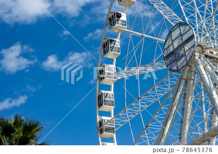 Ferris wheel in a sunny day with withe clouds Ferris wheel in a sunny day with withe clouds 78645376