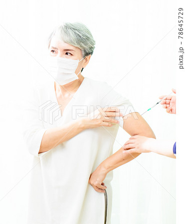Senior asian woman receiving the injection of the coronavirus vaccine by a doctor to receive the antibodies, immunize the population. Senior asian woman receiving the injection of the coronavirus vaccine by a doctor to receive the antibodies, immunize the population. 78645729