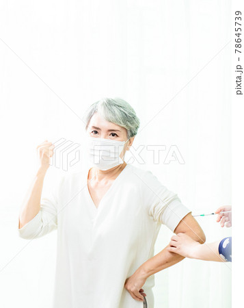 Senior asian woman receiving the injection of the coronavirus vaccine by a doctor to receive the antibodies, immunize the population. Senior asian woman receiving the injection of the coronavirus vaccine by a doctor to receive the antibodies, immunize the population. 78645739