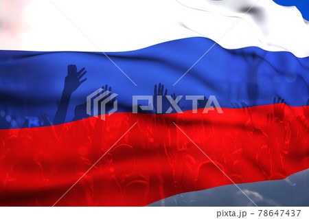 football fans supporting Russia  - crowd celebrating in stadium with raised hands against Russia flag 78647437