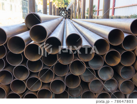 A bunch of large metal pipes. 78647803