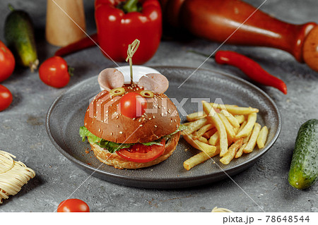 Children's burger in the form of a mouse. Burger from the children's menu with fries and sauce Children's burger in the form of a mouse. Burger from the children's menu with fries and sauce 78648544
