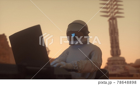 Astronaut in the space suit works on a laptop in a space colony on one of the planets. 3d rendering Astronaut in the space suit works on a laptop in a space colony on one of the planets. 3d rendering 78648898