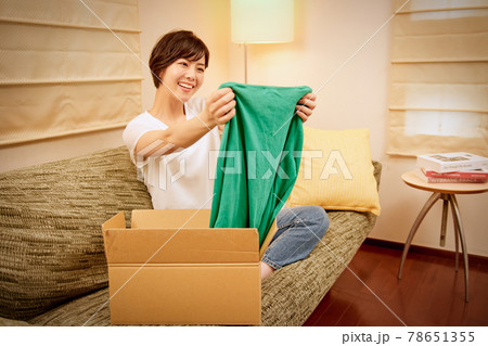 通信販売で買った商品が届き喜ぶ笑顔の若い女性 通信販売で買った商品が届き喜ぶ笑顔の若い女性 78651355