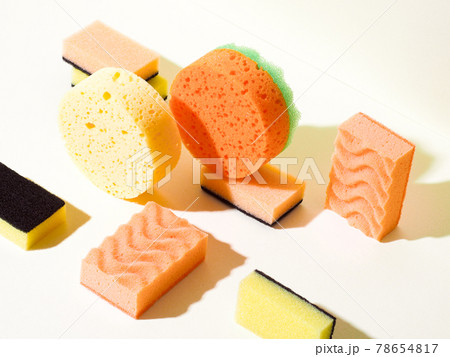 Foam rubber sponges in different shapes on yellow 78654817