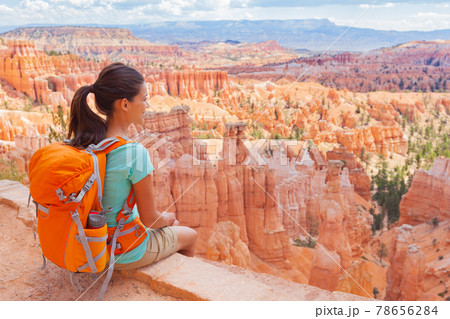 USA Hiker woman in Bryce Canyon hiking relaxing looking at view during hike wearing backpack on summer travel. Bryce Canyon National Park landscape, Utah, United States USA Hiker woman in Bryce Canyon hiking relaxing looking at view during hike wearing backpack on summer travel. Bryce Canyon National Park landscape, Utah, United States 78656284