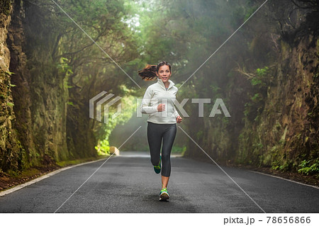 Running woman in autumn forest training on cold morning. Outdoor sport Asian girl athlete runner jogging outside fitness winter motivation Running woman in autumn forest training on cold morning. Outdoor sport Asian girl athlete runner jogging outside fitness winter motivation 78656866