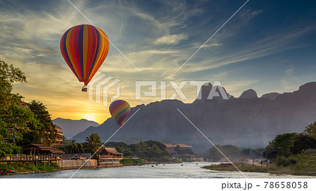 Nam Song river at sunset with hot air balloon in Vang Vieng, Laos, Beautifull landscape on the Nam Song River in Vang Vieng, Laos. 78658058