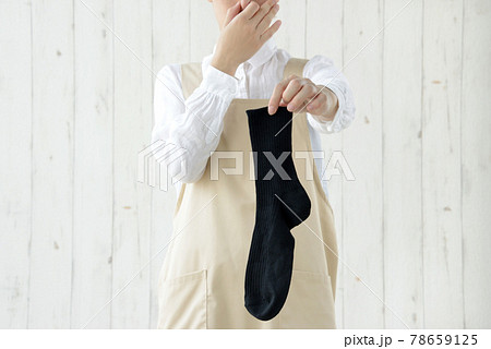 室内干しの靴下の匂いが気になる主婦の写真素材