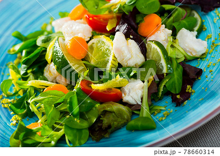Tasty salad of hake, lemon, lettuce leaves and fresh carrots Tasty salad of hake, lemon, lettuce leaves and fresh carrots 78660314