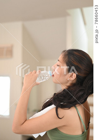 Beautiful young woman drinking a fresh of water at home. Beautiful young woman drinking a fresh of water at home. 78660453