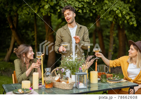 Friends having a festive dinner in nature Friends having a festive dinner in nature 78662608