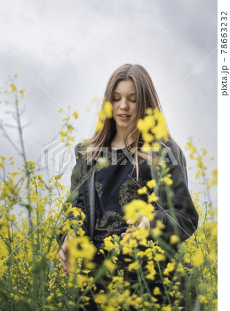 Young girl on yellow rapeseed field Young girl on yellow rapeseed field 78663232