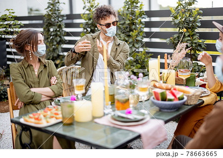 Friends in face mask dining outdoors Friends in face mask dining outdoors 78663665