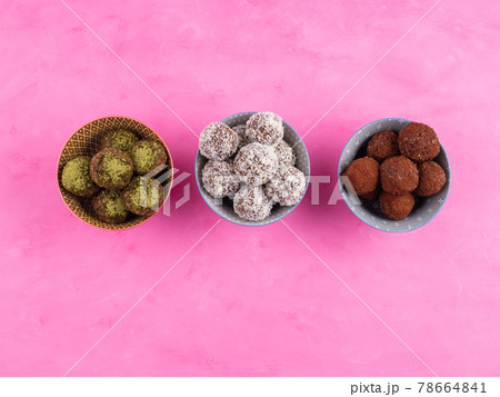 Healthy energy balls with nut butter, dried fruit, oats, seeds. Cocoa, coconut and matcha flavours 78664841