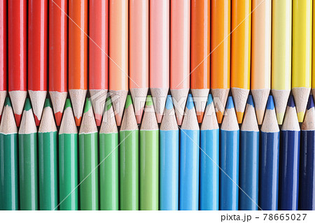 Many shades of sharp multicolored wooden pencils lying in colors of rainbow closeup background Many shades of sharp multicolored wooden pencils lying in colors of rainbow closeup background 78665027