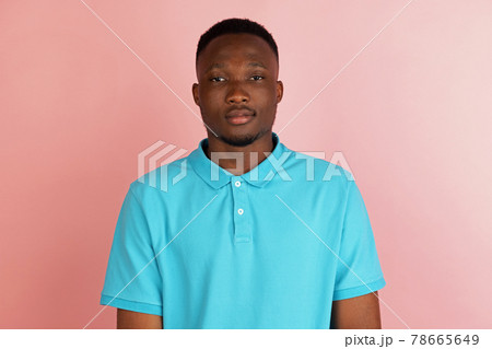 African american young male portrait isolated on pink studio background with copyspace for ad. African american young male portrait isolated on pink studio background with copyspace for ad. 78665649
