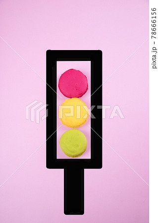 Traffic light made of macaroons cookies on a pink paper background. Copy space Traffic light made of macaroons cookies on a pink paper background. Copy space 78666156