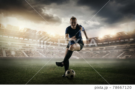 Female soccer, football player dribbling ball in motion at the stadium during sport match on cloudy sky background. Collage Female soccer, football player dribbling ball in motion at the stadium during sport match on cloudy sky background. Collage 78667120