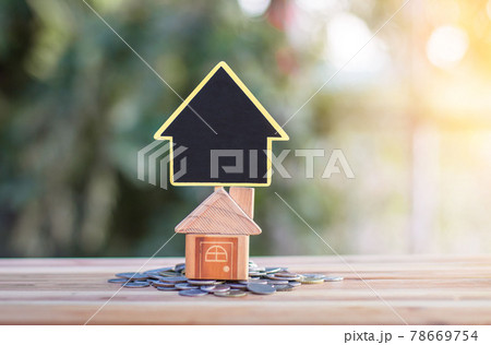 House signs and model houses are placed on coins. indicating the growth of the savings business to buy a house. House signs and model houses are placed on coins. indicating the growth of the savings business to buy a house. 78669754