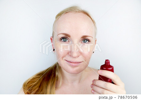 A young woman puts a gel mask on her face. Care for oily, problem skin A young woman puts a gel mask on her face. Care for oily, problem skin 78670506