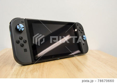 Thailand , Bangkok - Jun 8, 2021 A Nintendo Switch game console on table. Thailand , Bangkok - Jun 8, 2021 A Nintendo Switch game console on table. 78670660