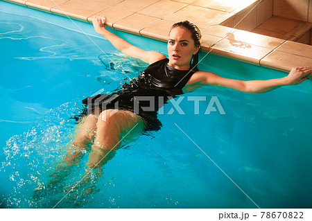 Sexy seductive woman relaxing in water at poolside 78670822