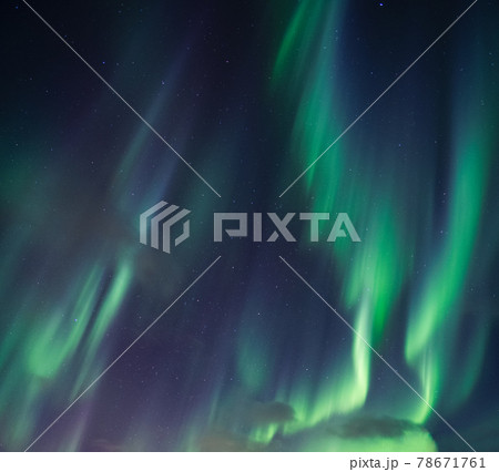 Aurora borealis, Northern lights with stars glowing in the night sky 78671761
