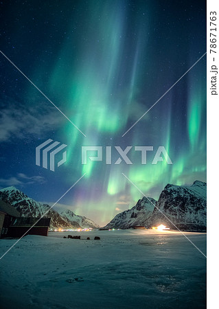 Aurora borealis, Northern lights with stars glowing on snowy mountain in the night sky on winter at Lofoten Islands 78671763