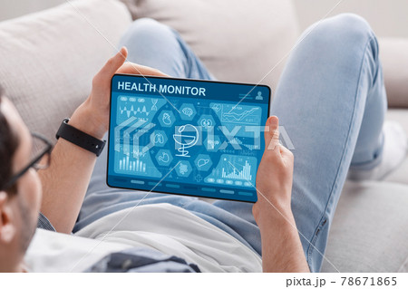 Relaxed man using brand new health application on tablet 78671865