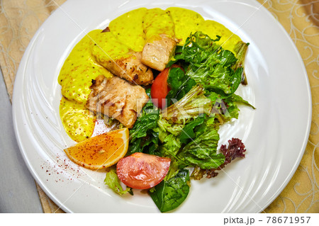 Baked pelengas fillet with salad mix with mustard-cream sauce. Close-up, selective focus 78671957