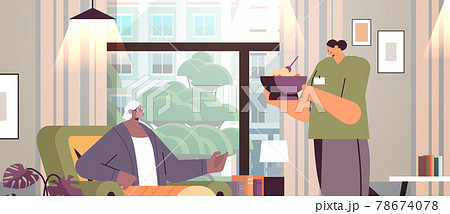 friendly nurse or volunteer bringing food to elderly woman patient home care services healthcare and social support 78674078