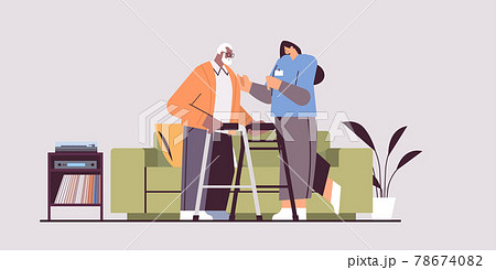 nurse or volunteer supporting elderly man with walkers home care services healthcare and social support nurse or volunteer supporting elderly man with walkers home care services healthcare and social support 78674082