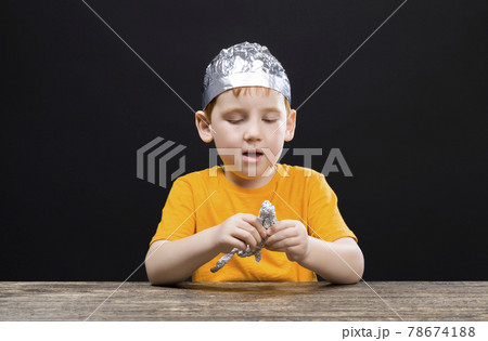 a beautiful red-haired boy with a homemade foil hat 78674188